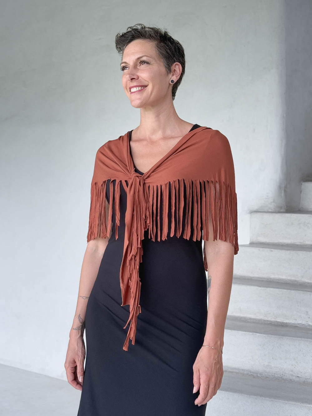 caraucci-fringe-scarf-orange-worn-as-shawl-over-black-dress #color_copper