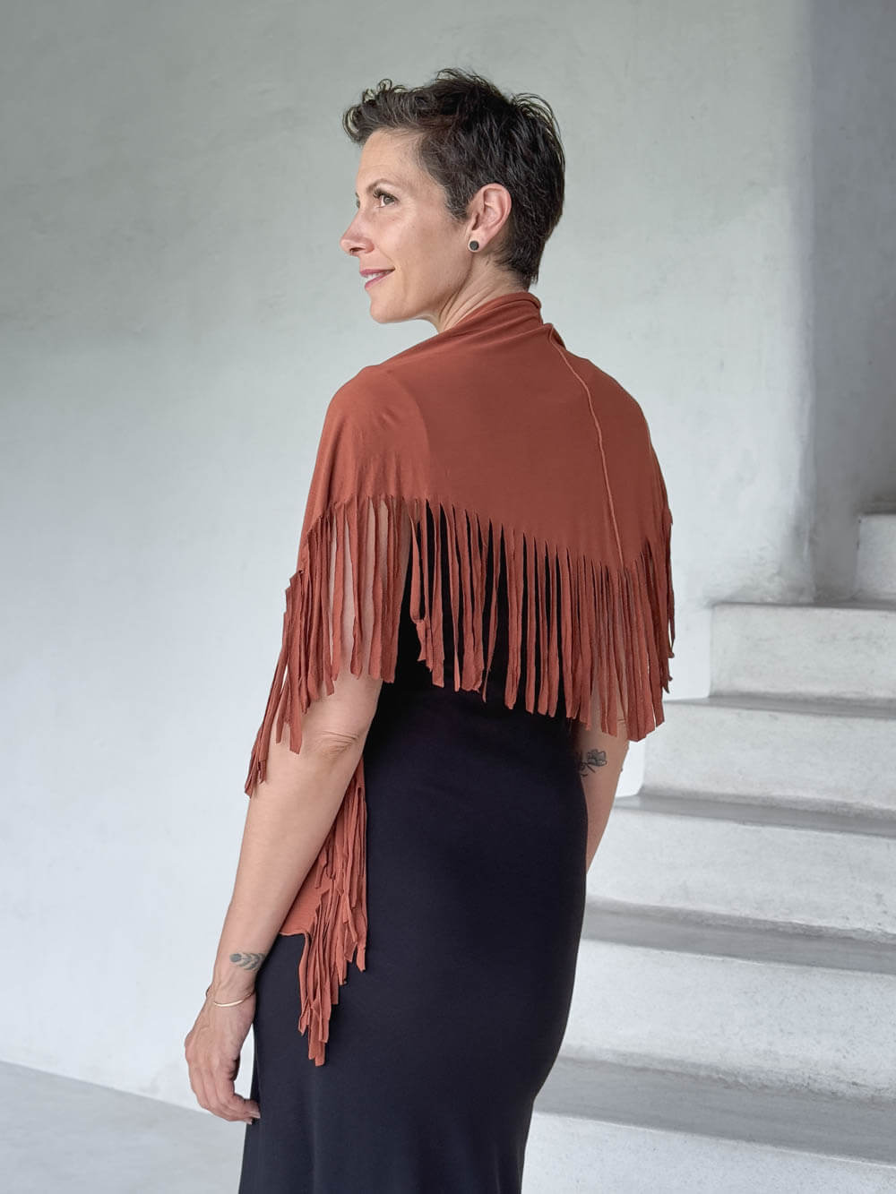 caraucci-fringe-scarf-orange-worn-as-shawl-over-black-dress #color_copper
