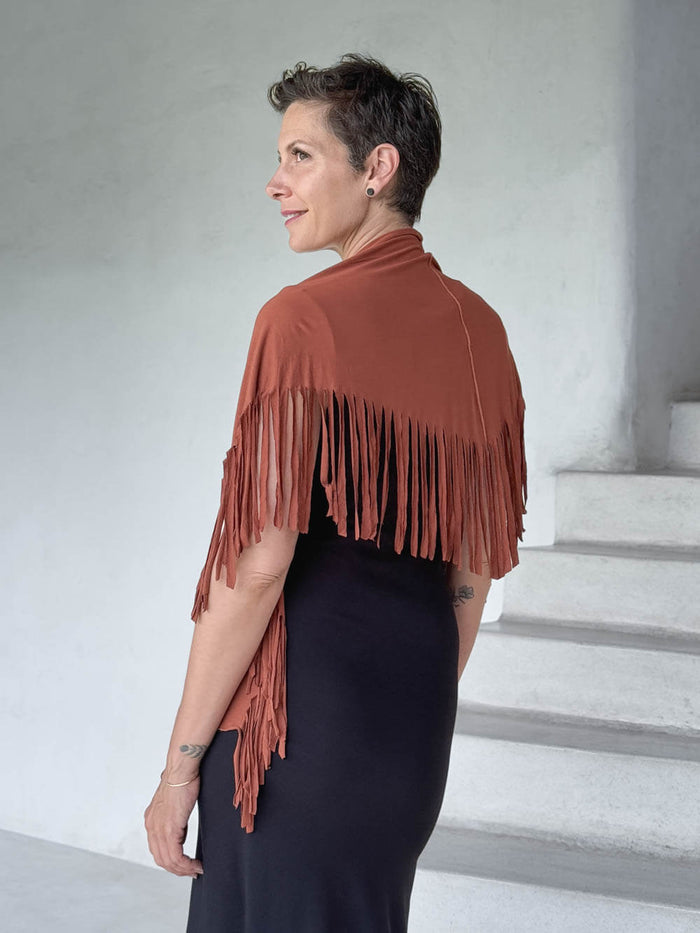 caraucci-fringe-scarf-orange-worn-as-shawl-over-black-dress #color_copper