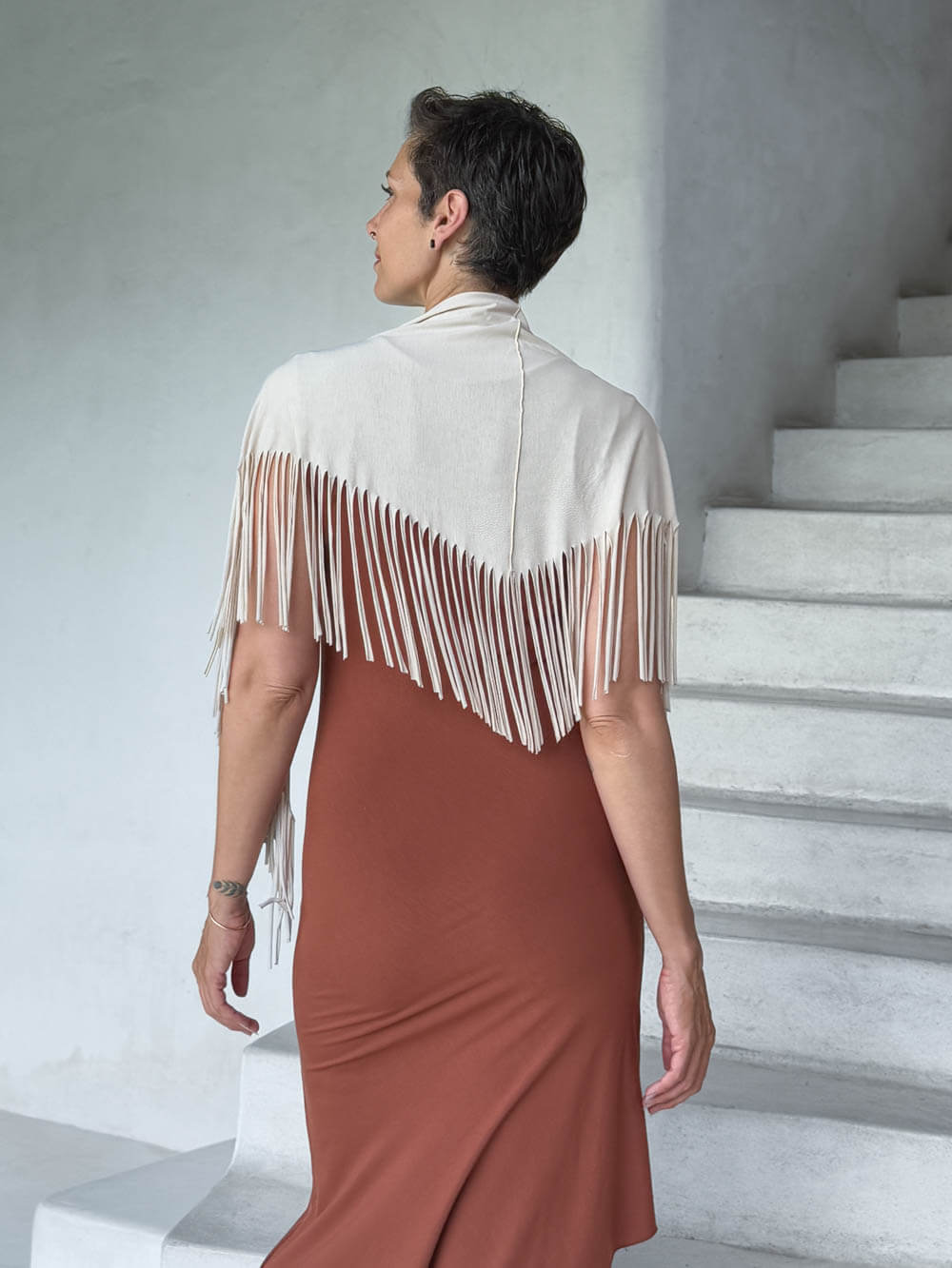 caraucci-fringe-scarf-cream-worn-as-shawl-over-copper-dress #color_cream