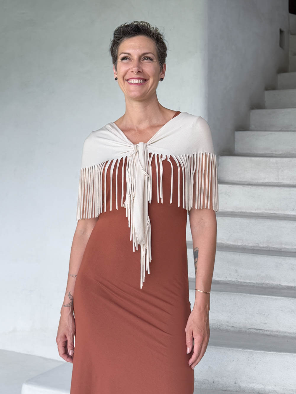 caraucci-fringe-scarf-cream-worn-as-shawl-over-copper-dress #color_cream