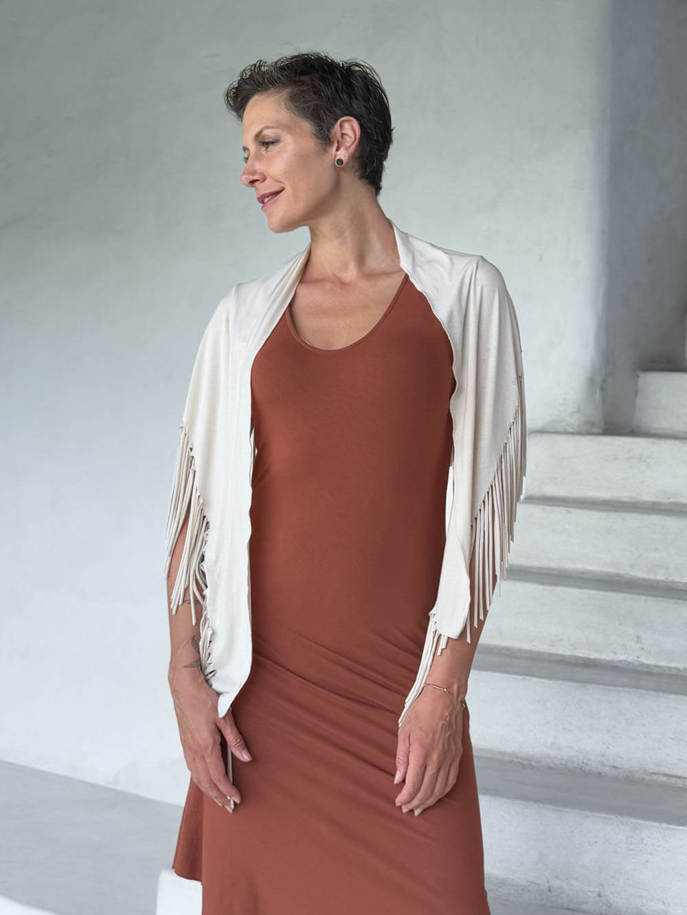 caraucci-fringe-scarf-cream-worn-as-shawl-over-copper-dress #color_cream