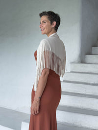 caraucci-fringe-scarf-cream-worn-as-shawl-over-copper-dress #color_cream