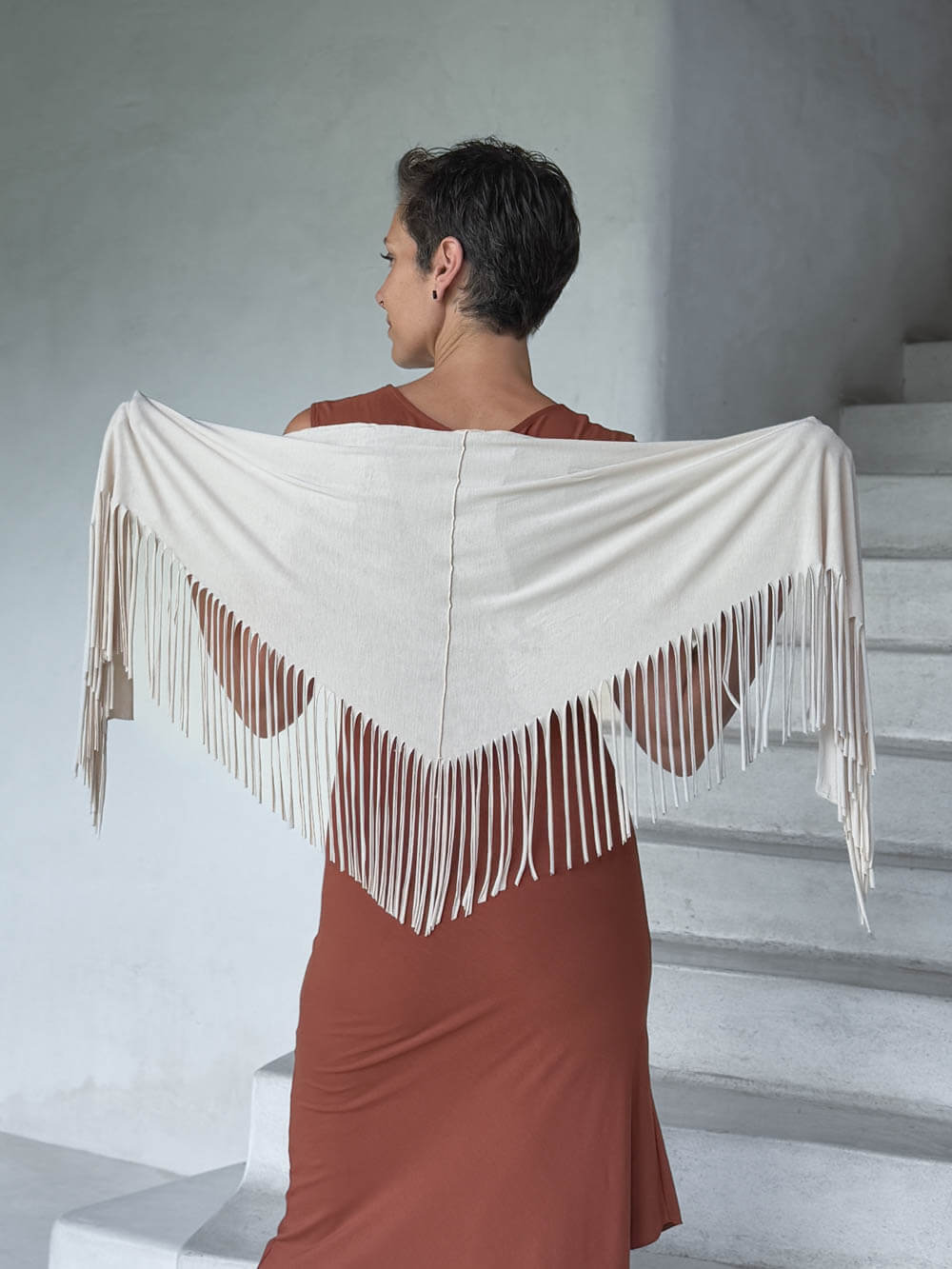 caraucci-fringe-scarf-cream-worn-as-shawl-over-copper-dress #color_cream