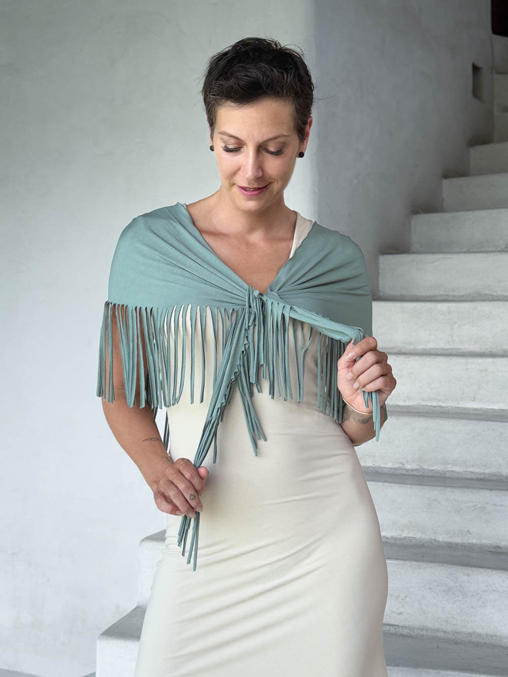 caraucci-fringe-scarf-sage-green-worn-as-shawl-over-cream-dress #color_moss