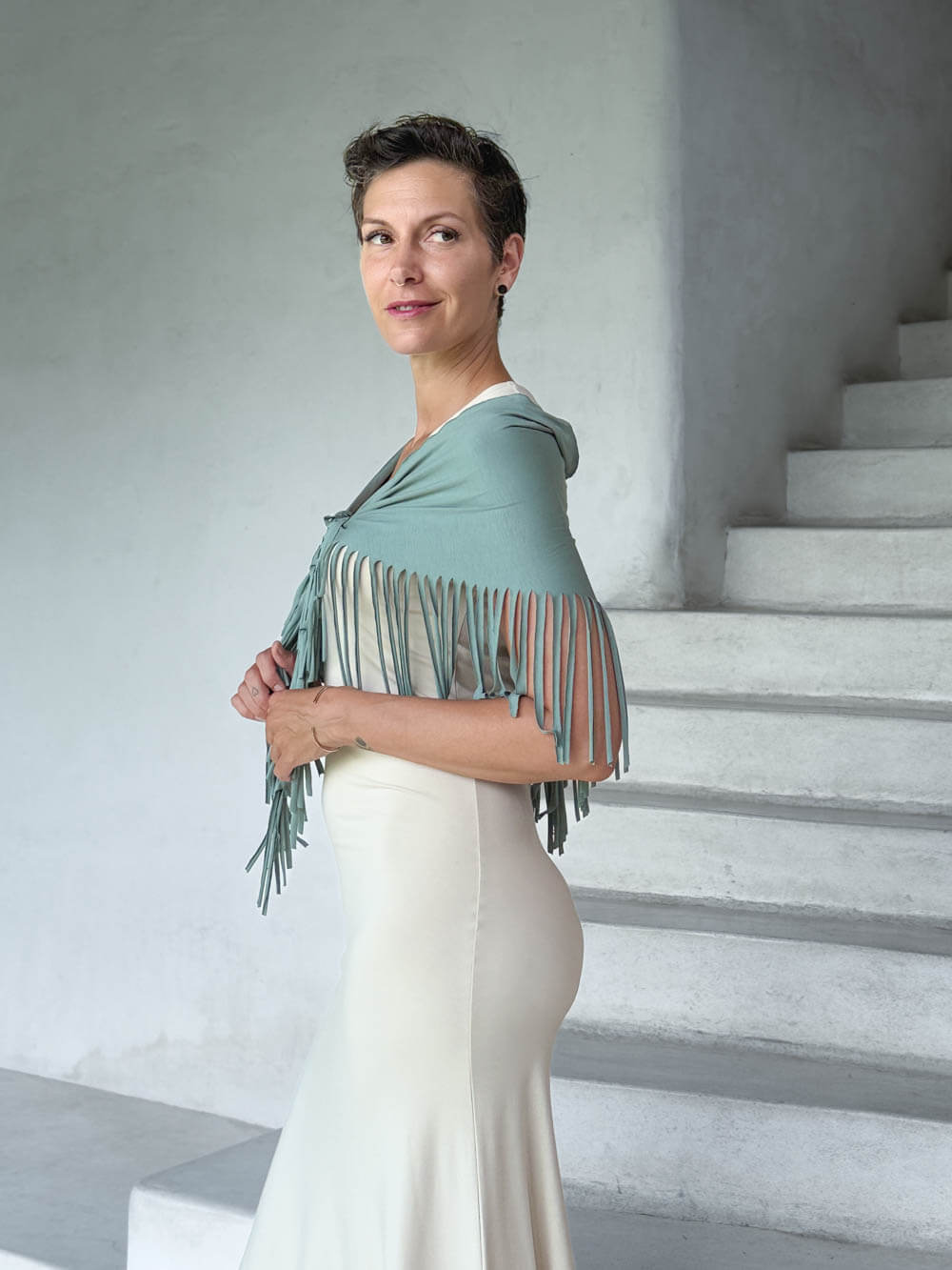 caraucci-fringe-scarf-sage-green-worn-as-shawl-over-cream-dress #color_moss