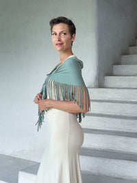 caraucci-fringe-scarf-sage-green-worn-as-shawl-over-cream-dress #color_moss