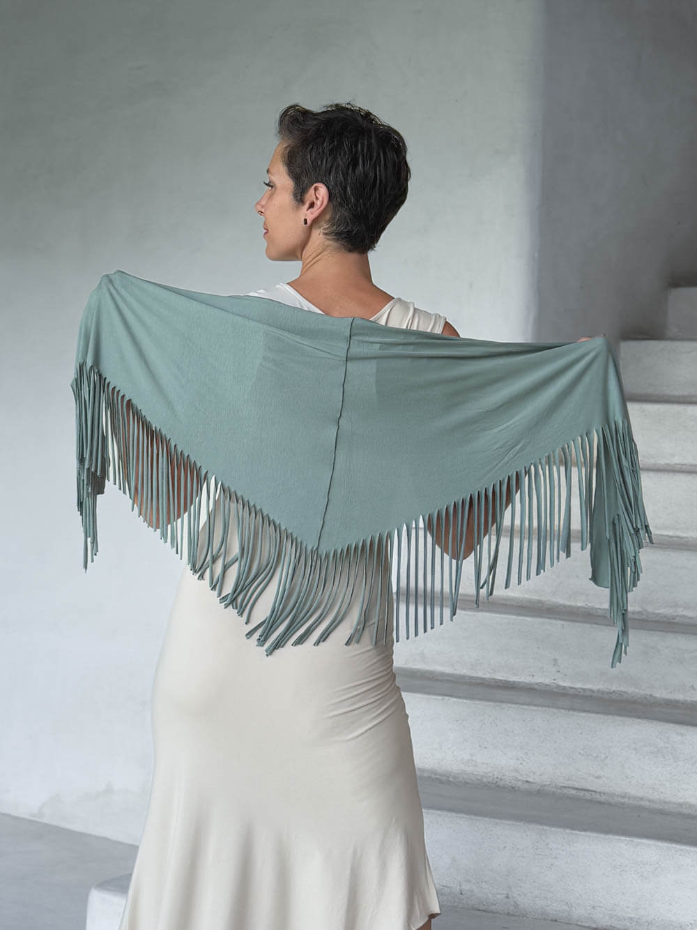 caraucci-fringe-scarf-sage-green-worn-as-shawl-over-cream-dress #color_moss