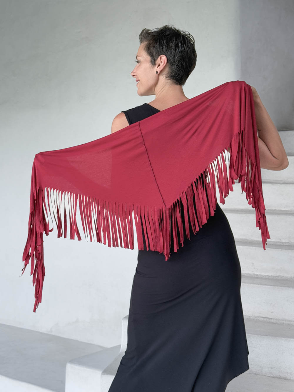 caraucci-fringe-scarf-red-worn-as-shawl-over-black-dress #color_scarlet