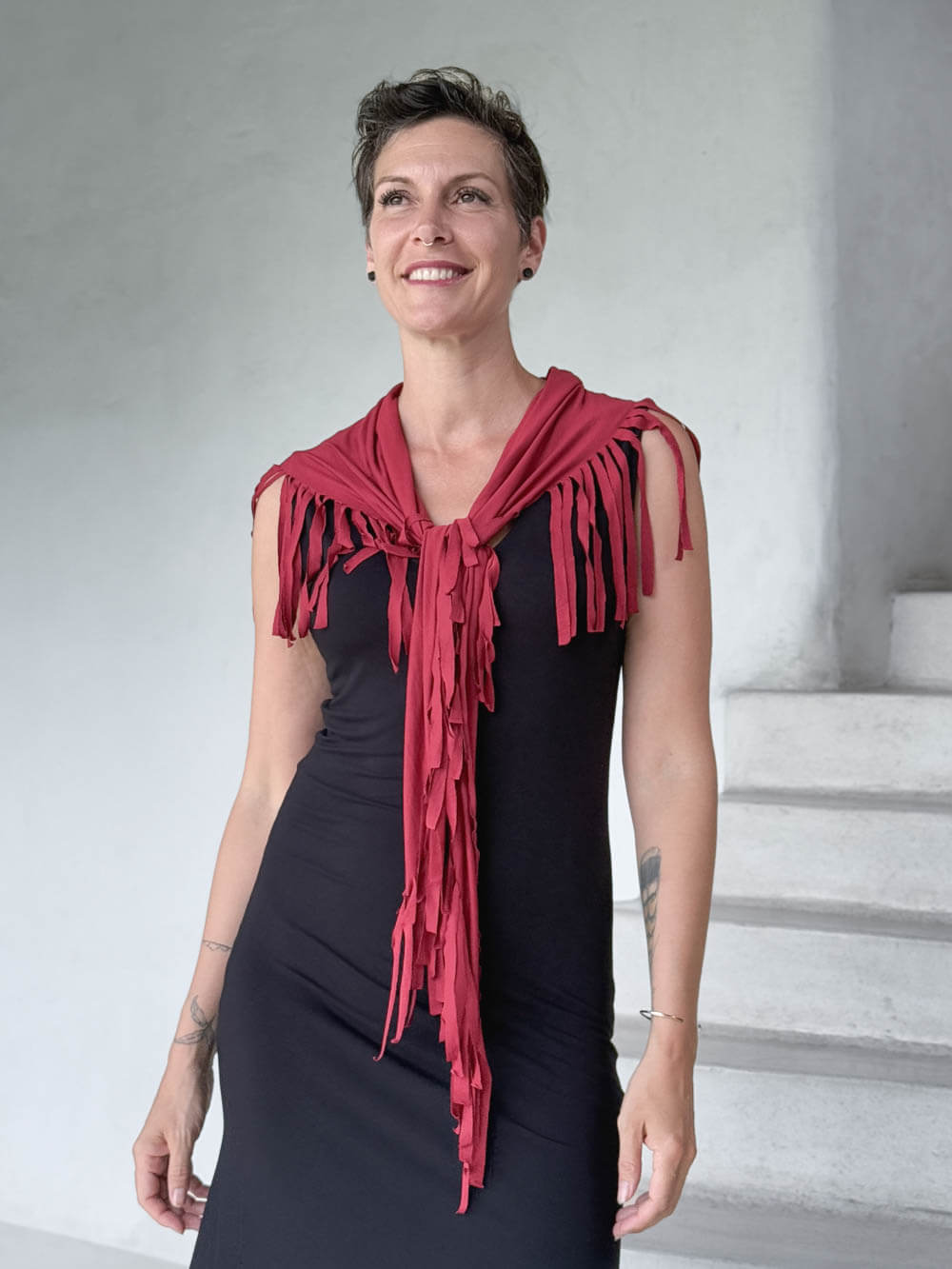 caraucci-fringe-scarf-red-worn-as-shawl-over-black-dress #color_scarlet