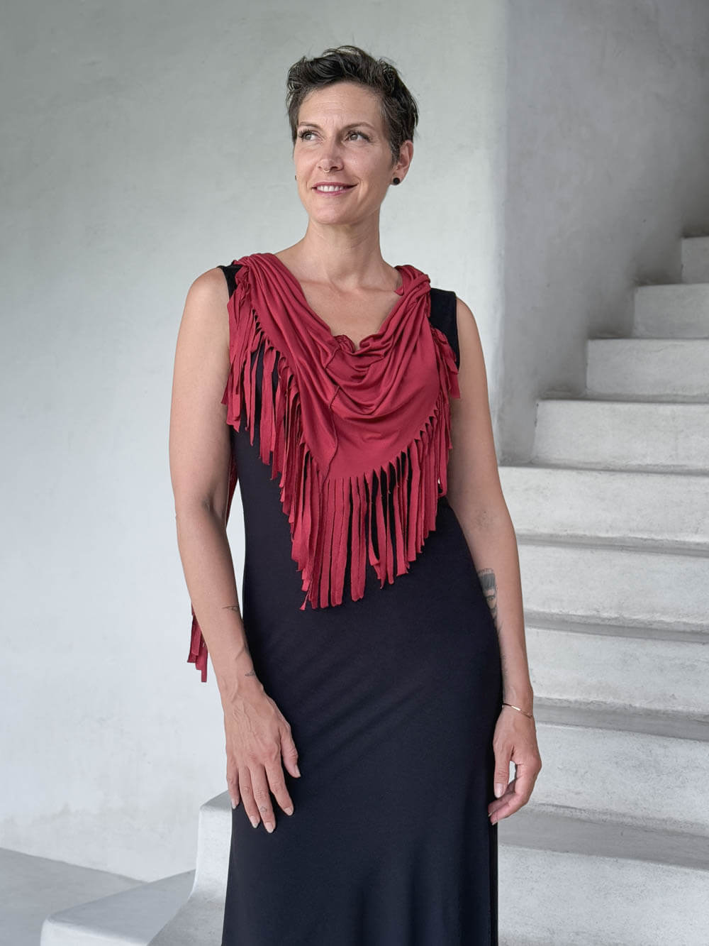 caraucci-fringe-scarf-red-worn-as-shawl-over-black-dress #color_scarlet