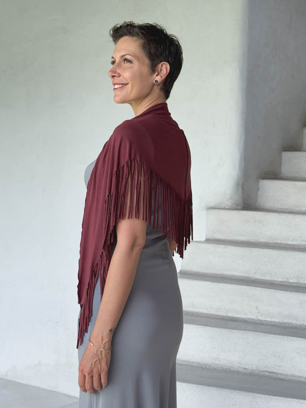 caraucci-fringe-scarf-maroon-worn-as-shawl-over-stone-dress #color_wine