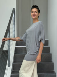 caraucci gray dolman sleeve draped tunic worn as a tunic with cream pants #color_stone