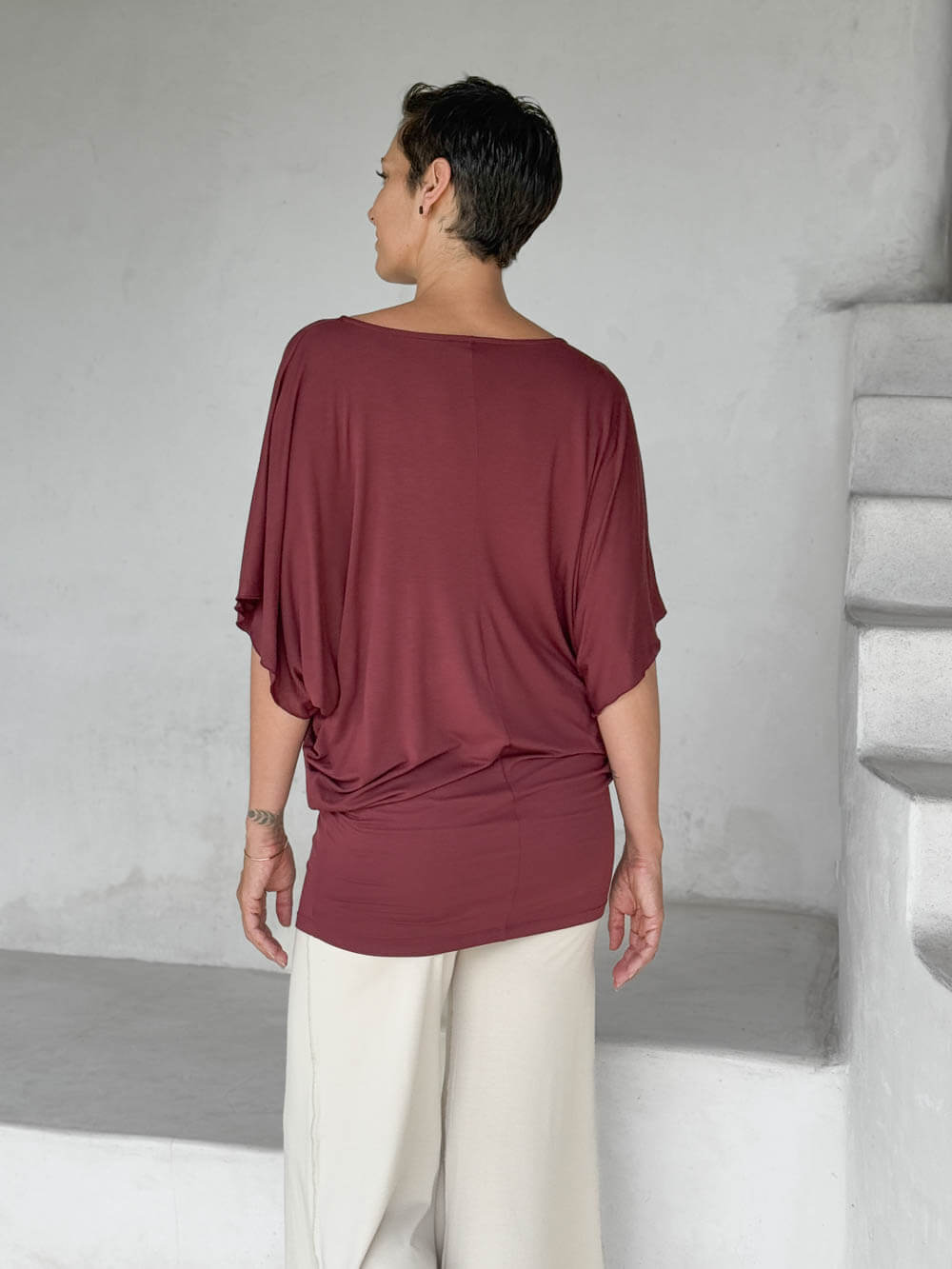 caraucci maroon kimono tunic worn as a tunic with cream pants #color_wine