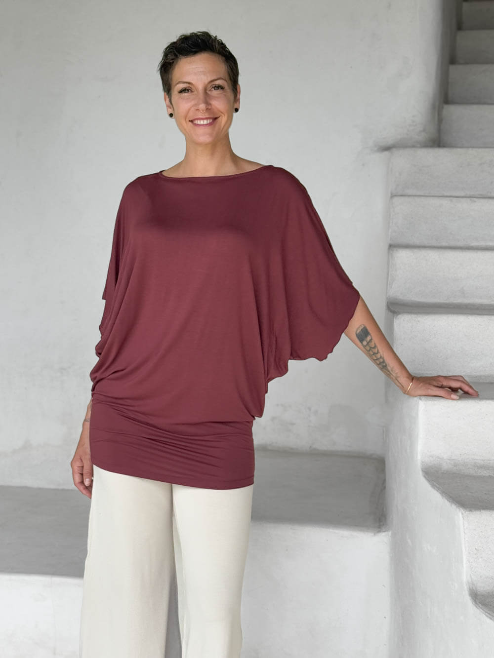 caraucci maroon kimono tunic worn as a tunic with cream pants #color_wine