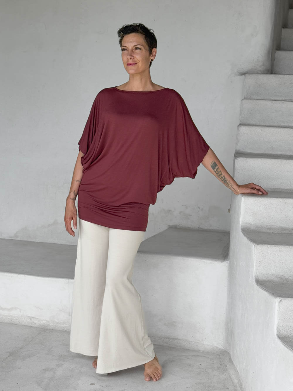 caraucci maroon kimono tunic worn as a tunic with cream pants #color_wine