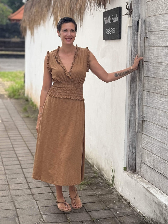 caraucci camel midi-length dress with smocked waist and sleeveless ruffled neckline and pockets #color_camel