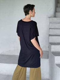 caraucci-woman-wearing-black-v-neck-tunic-and-brass-wide-leg-pants #color_black