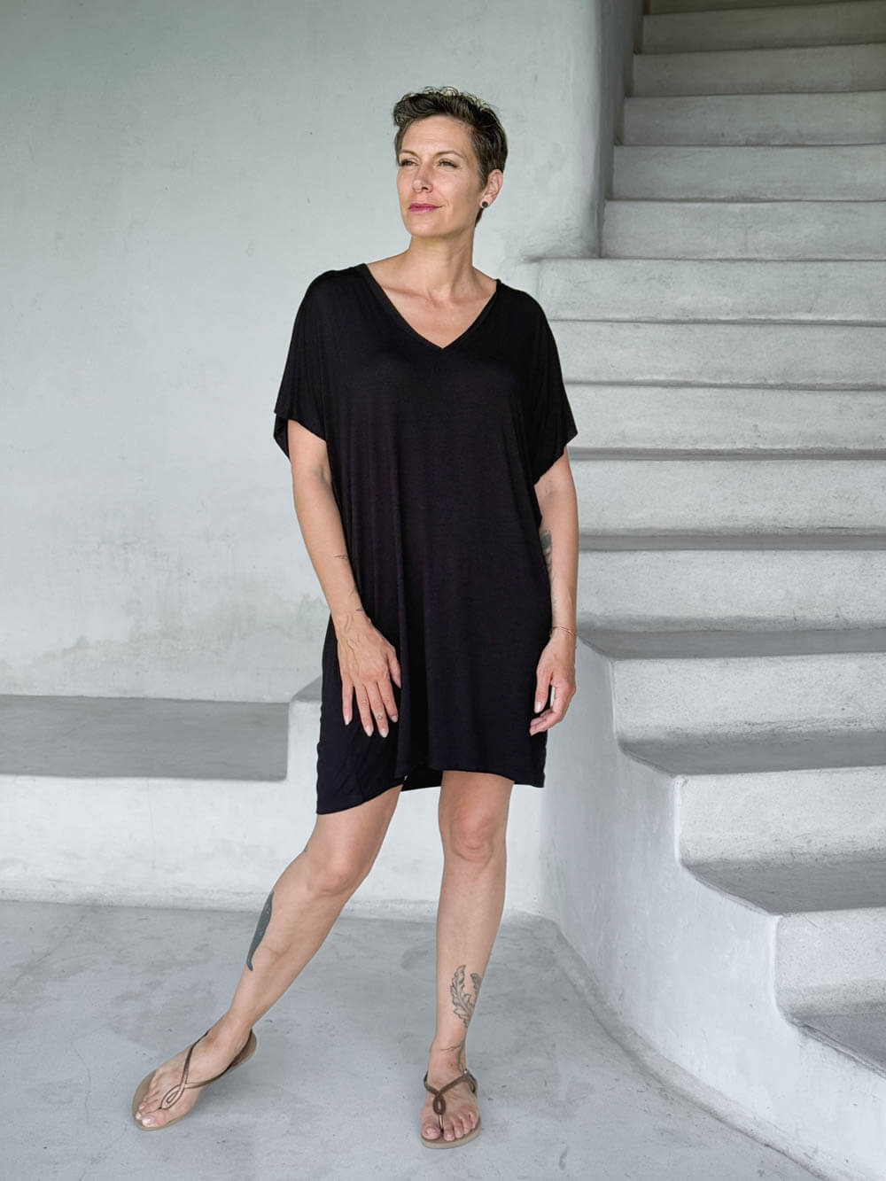 caraucci-woman-wearing-black-v-neck-tunic-as-a-dress #color_black