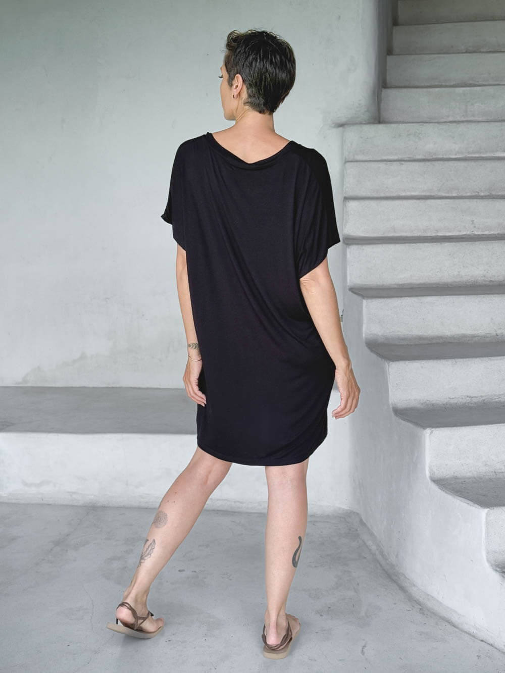caraucci-woman-wearing-black-v-neck-tunic-as-a-dress #color_black