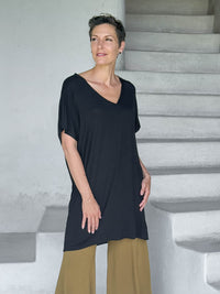 caraucci-woman-wearing-black-v-neck-tunic-and-brass-wide-leg-pants #color_black