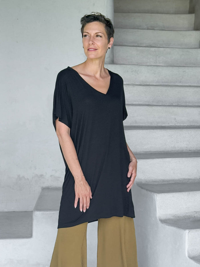 caraucci-woman-wearing-black-v-neck-tunic-and-brass-wide-leg-pants #color_black