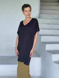 caraucci-woman-wearing-black-v-neck-tunic-and-brass-wide-leg-pants #color_black
