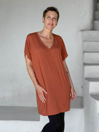 caraucci-woman-wearing-copper-v-neck-tunic-and-black-leggings #color_copper