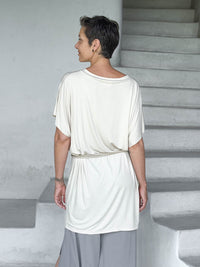 caraucci-woman-wearing-cream-v-neck-tunic-and-a-belt #color_cream