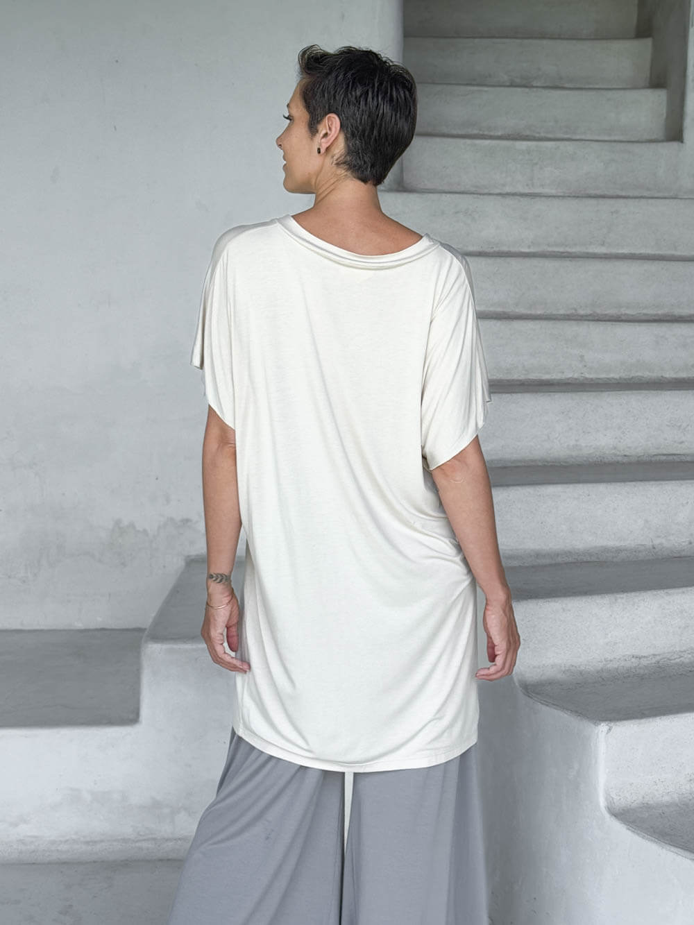 caraucci-woman-wearing-cream-v-neck-tunic-and-light-grey-wide-leg-pants #color_cream