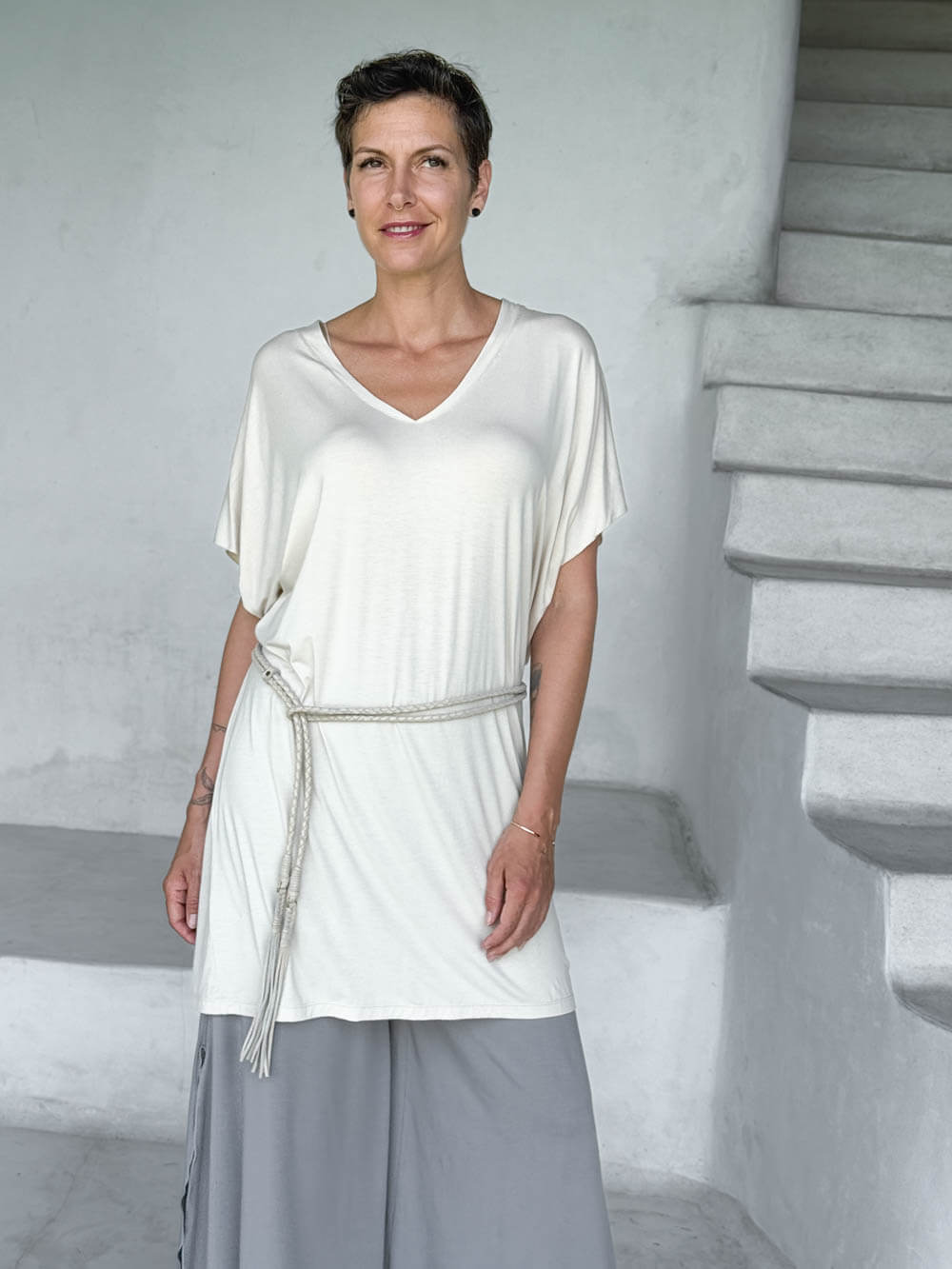 caraucci-woman-wearing-cream-v-neck-tunic-and-a-belt-and-light-grey-wide-leg-pants #color_cream