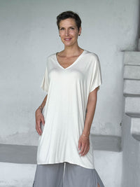caraucci-woman-wearing-cream-v-neck-tunic-and-light-grey-wide-leg-pants #color_cream