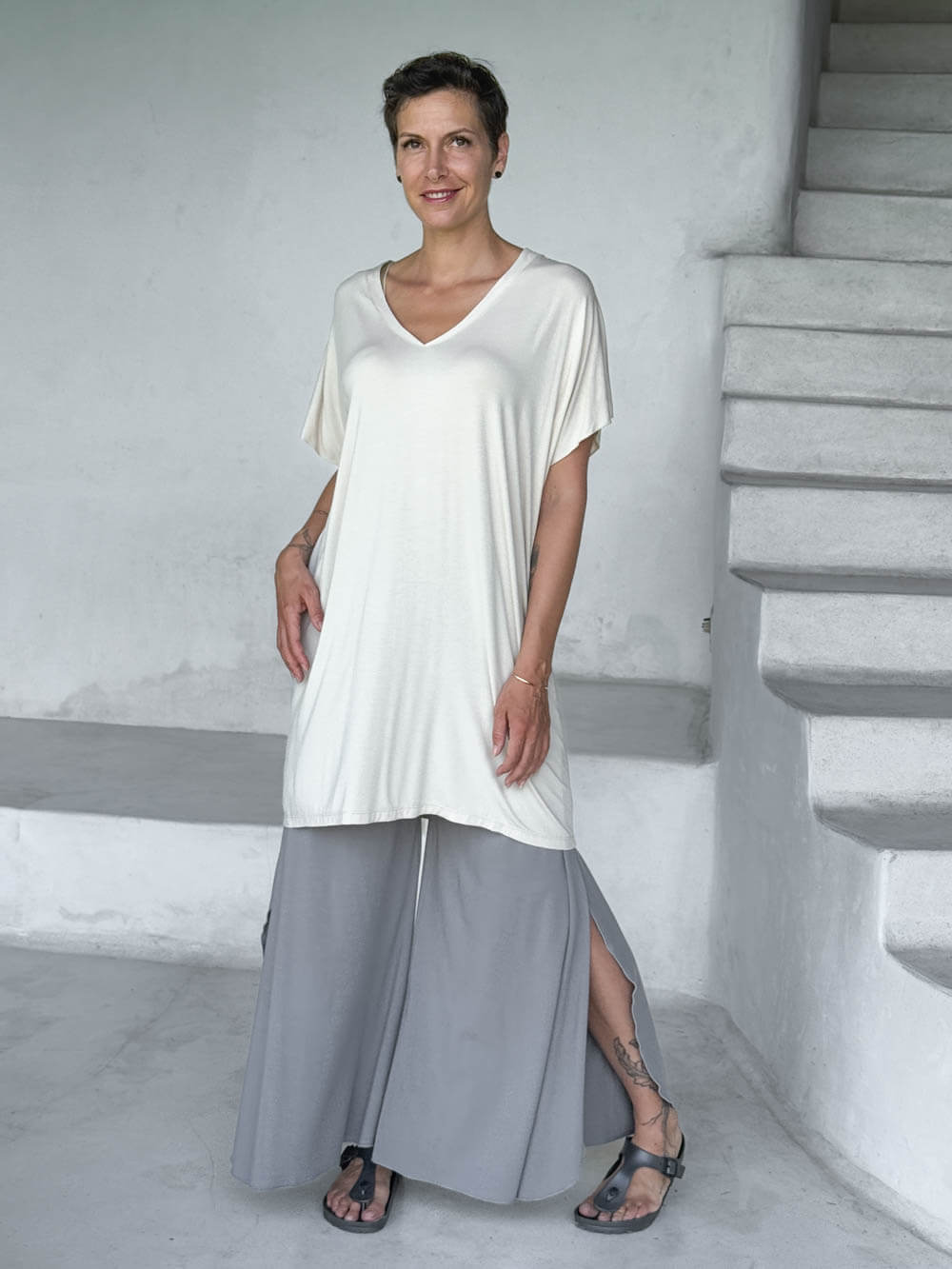 caraucci-woman-wearing-cream-v-neck-tunic-and-light-grey-wide-leg-pants #color_cream