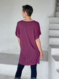 caraucci-woman-wearing-purple-v-neck-tunic-and-black-leggings #color_jam