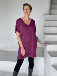 caraucci-woman-wearing-purple-v-neck-tunic-and-black-leggings #color_jam