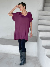 caraucci-woman-wearing-purple-v-neck-tunic-and-black-leggings #color_jam