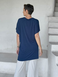 caraucci-woman-wearing-navy-v-neck-tunic-and-cream-wide-leg-pants #color_navy