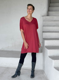caraucci-woman-wearing-red-v-neck-tunic-and-black-leggings #color_scarlet