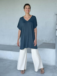 caraucci-woman-wearing-teal-v-neck-tunic-and-cream-wide-leg-pants #color_teal