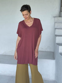 caraucci-woman-wearing-maroon-v-neck-tunic-and-brass-wide-leg-pants #color_wine