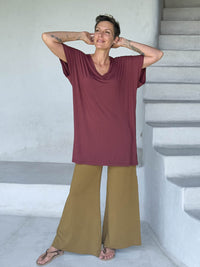 caraucci-woman-wearing-maroon-v-neck-tunic-and-brass-wide-leg-pants #color_wine