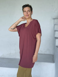 caraucci-woman-wearing-maroon-v-neck-tunic-and-brass-wide-leg-pants #color_wine