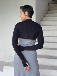 caraucci-woman-wearing-black-sleeve-shrug-layered-over-grey-dress-with-thumbhole-detail #color_black