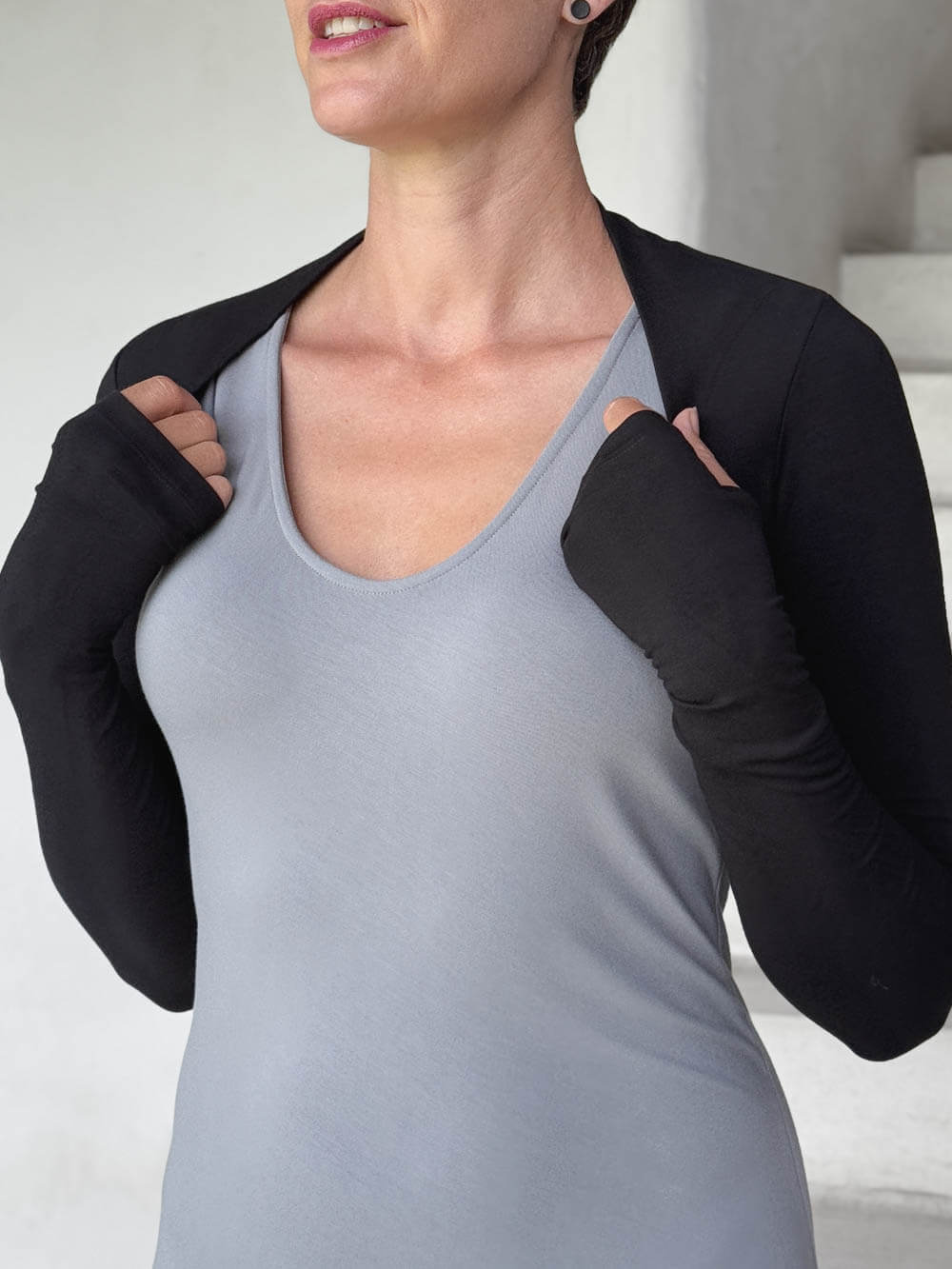 caraucci-woman-wearing-black-sleeve-shrug-layered-over-grey-dress-with-thumbhole-detail #color_black