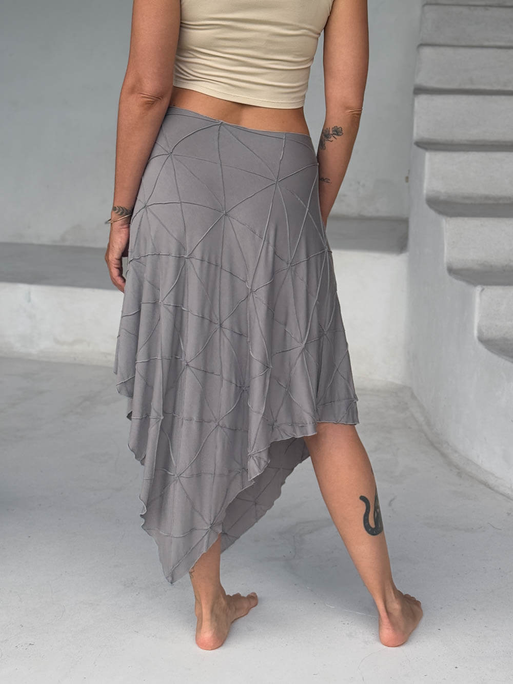 caraucci texture poncho worn as a skirt #color_stone