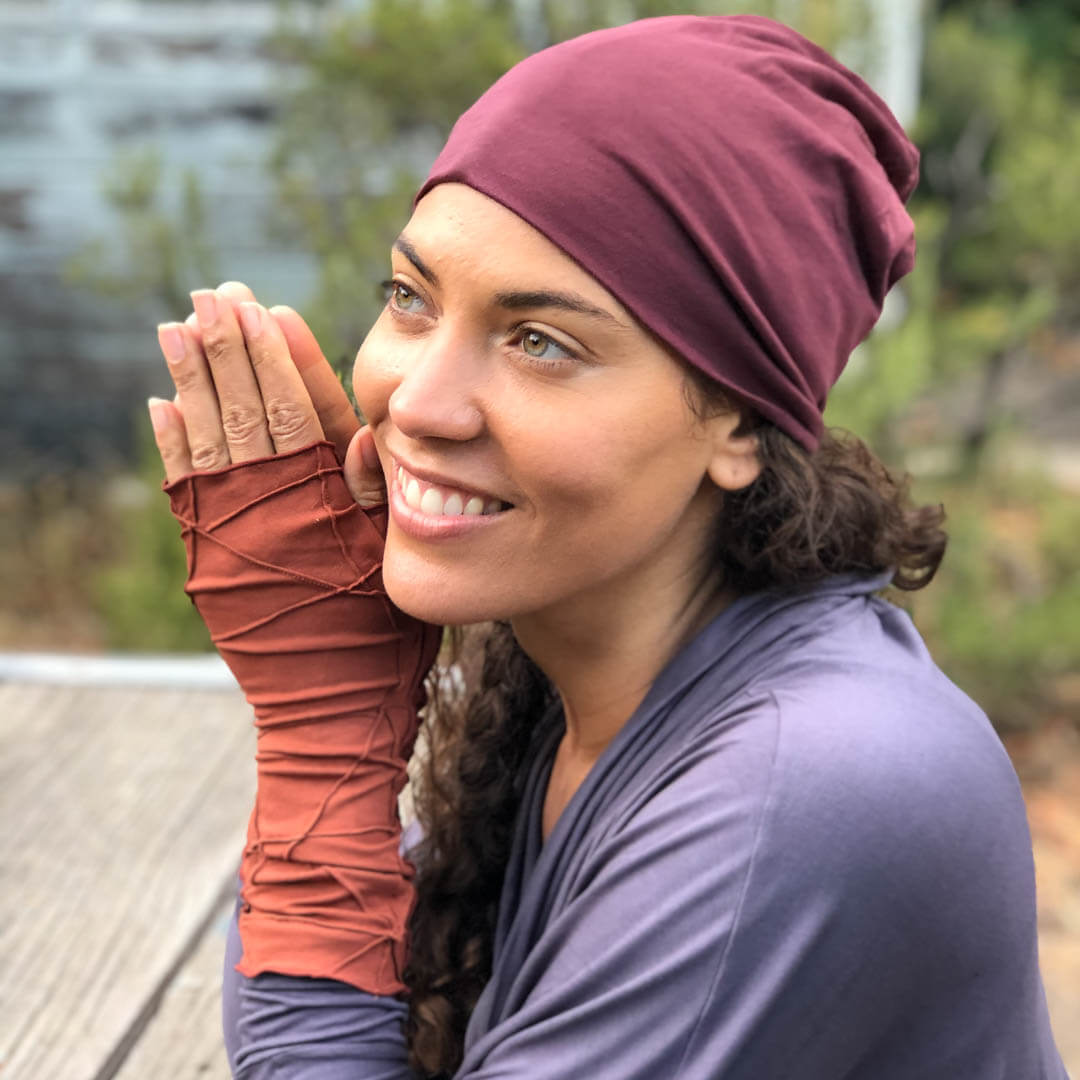 caraucci accessories collection featuring textured plant based rayon jersey stretchy fingerless gloves and pima cotton maroon beanie hat