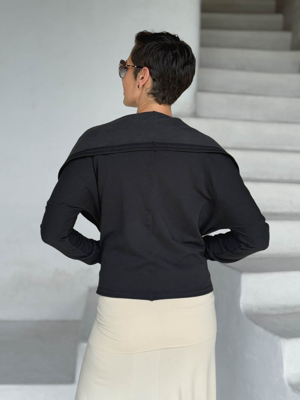 caraucci black bamboo fleece jacket, shown open from the back with a draped shawl color with thumbholes and pockets #color_black