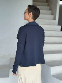 caraucci navy blue bamboo fleece jacket, shown open from the back with a draped shawl color with thumbholes and pockets #color_navy