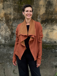 caraucci orange bamboo fleece jacket, shown open with a draped shawl color with thumbholes and pockets #color_copper