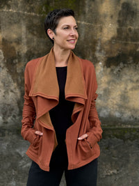 caraucci orange bamboo fleece jacket, shown open with a draped shawl color with thumbholes and pockets #color_copper